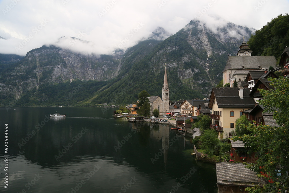 A view of a town with a lake and mountains in the background, Austria