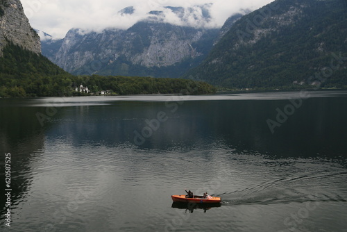 A man peacefully rowing a small boat on a lake, Austria