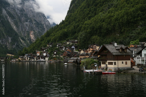 Photo of a serene lakeside town with colorful buildings and boats on the water, Austria