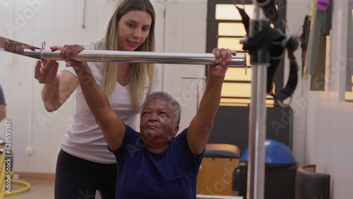 Female Pilates Coach Assisting Black Senior Woman in Machine Workout for Body Strengthening and Flexibility