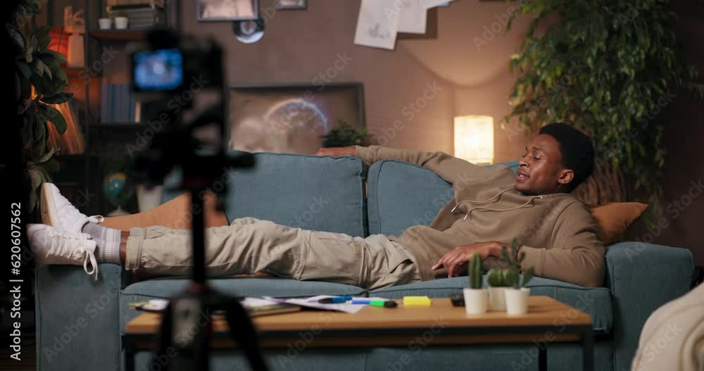 Musician and Songwriter relaxing on the couch, this man shares his musical talent with the camera. Musician and Songwriter relaxing on the couch, this man shares his musical talent with the camera.