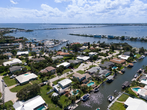 Aerial view of a Florida barrier island community along the intracoastal waterway looking toward a causeway.