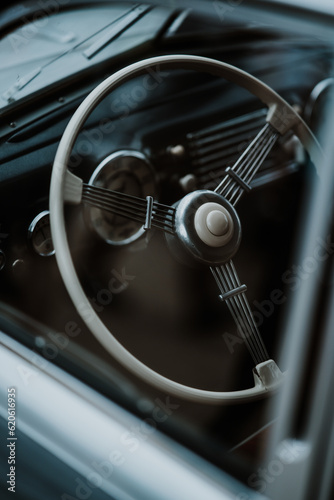 Oldtimer car dashboard. Retro car interior. Old steering wheel detail.