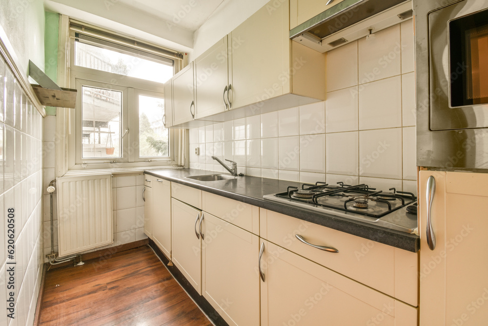 Fototapeta premium a kitchen with white cabinets and black counter tops in the center of the image is an oven, microwave, toaster and dishwasher