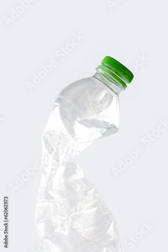 Empty rumpled used plastic bottle isolated on white background. Pollution, environmental protection concept. Reuse garbage, recycle, plastic free. Earth, world water day.