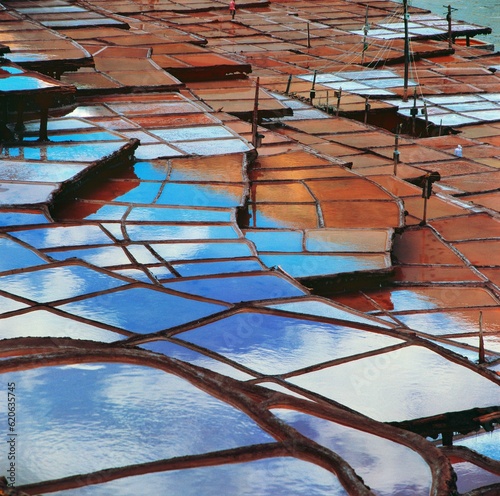 salt wells reflecting sky and clouds in Tibet