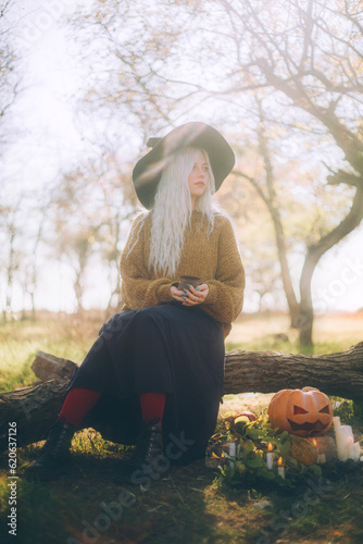 Girl dressed as a witch and Jack-o-lantern