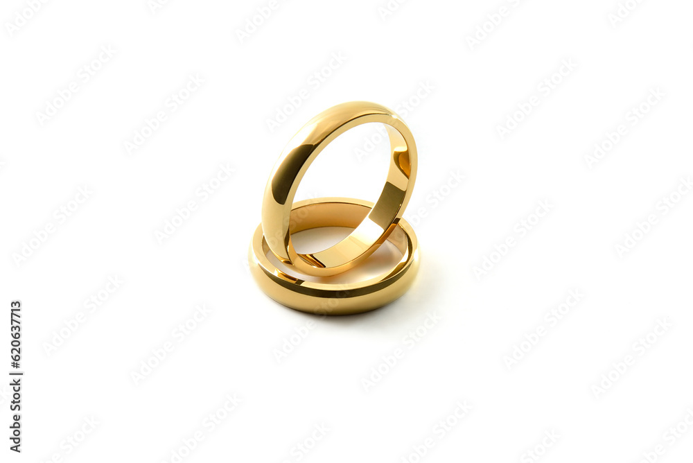 Engagement gold ring standing inside of each other on white isolated background Engagement gold ring standing inside of each other on white isolated background