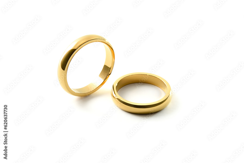 Engagement gold rings standing and lying down white isolated background Engagement gold rings standing and lying down white isolated background
