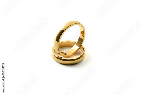 Engagement gold ring standing inside of each other on white isolated background