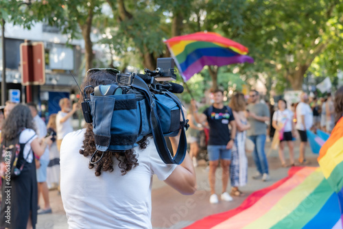television camera operator filming Pride Day demonstration