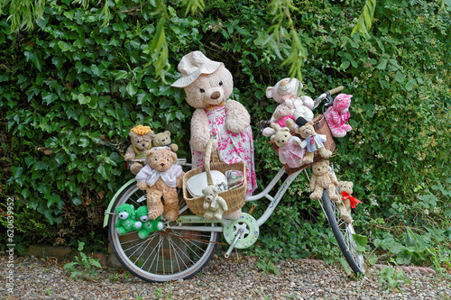 A Group of 14 Teddy Bears on an Old Bicycle