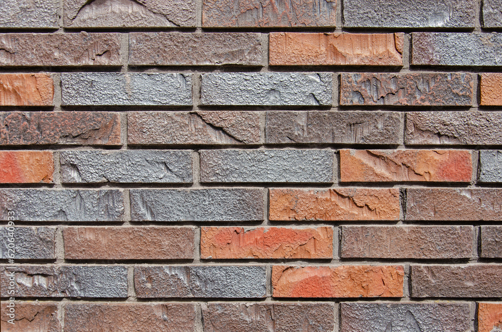Detail of a wall with modern bricks, artificially roughened, in various colors Detail of a wall with modern bricks, artificially roughened, in various colors