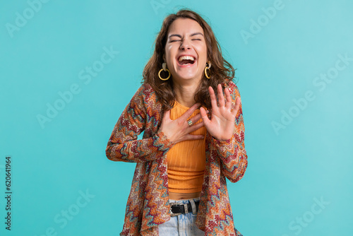 Amused lovely woman pointing finger to camera, laughing out loud, taunting making fun of ridiculous appearance, funny joke anecdote. Pretty brunette girl isolated alone on blue studio background
