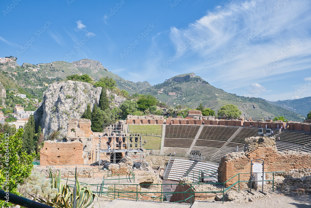 Naklejka premium ancient theater in Taormina mountains in the background, Sicily, Italy