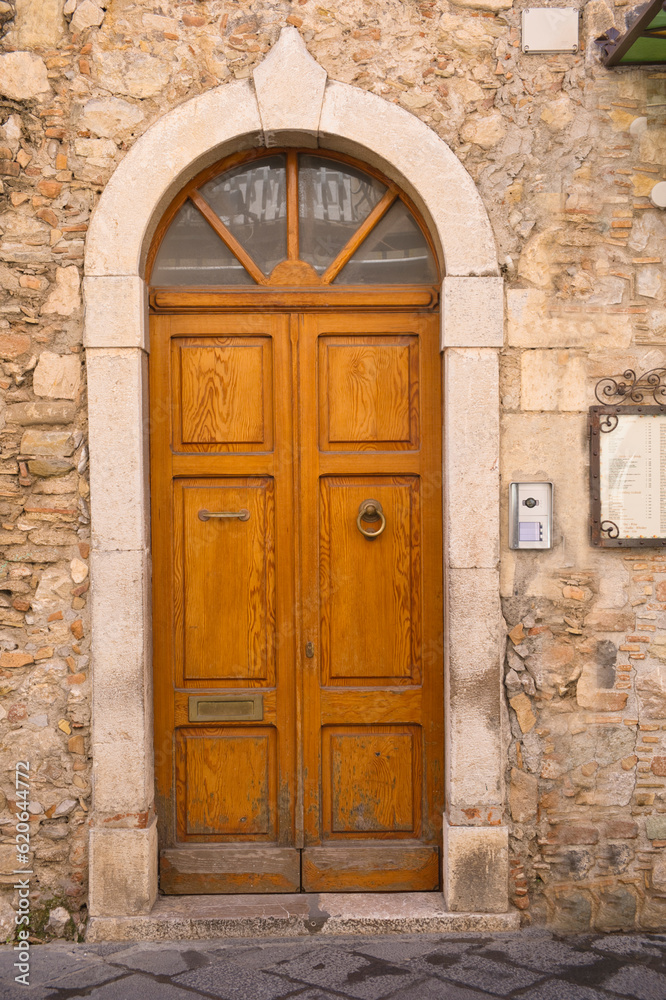 old wooden front door in Taormina, Sicily, Italy