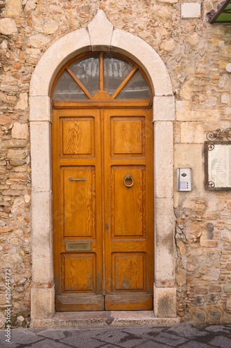 old wooden front door in Taormina, Sicily, Italy