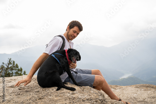 Man and dog at viewpoint nature