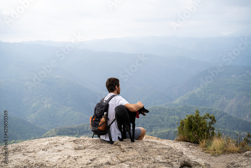 Man and dog at viewpoint nature