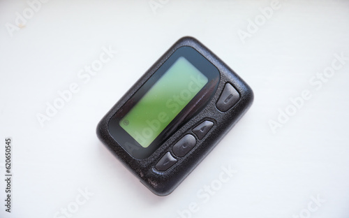 pager beeper lies on a desk, symbolizing instant communication and connection, bridging distances and enabling efficient messaging in the digital age