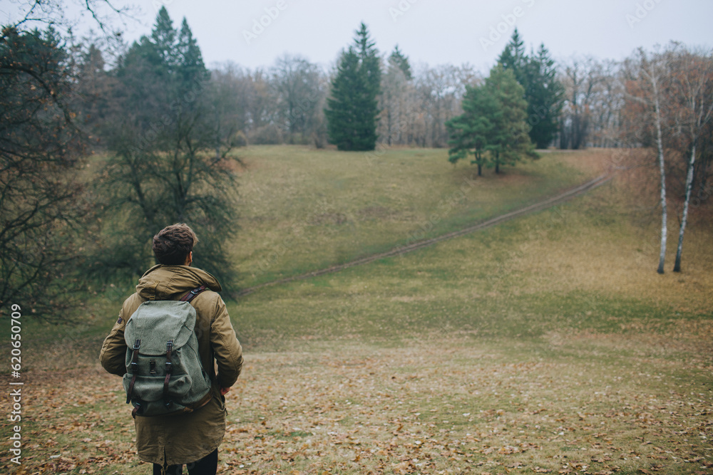 Man hiking in forest with backpack Man hiking in forest with backpack