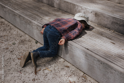 Child lying on step photo