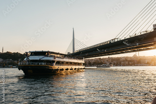 Golden hour photo of ship going under bridge on sea photo
