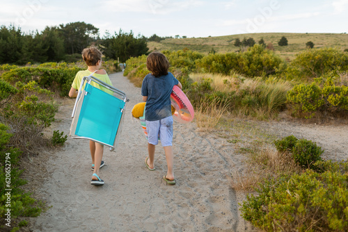 Children equipped walking towards the beach