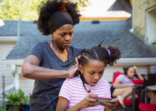 Mother combing her child's kinky curly coily hair