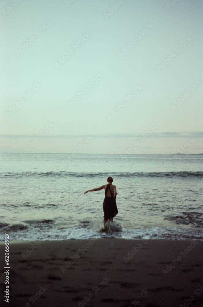 Film Portrait Of Anonymous Woman Standing At The Beach In Waves Film Portrait Of Anonymous Woman Standing At The Beach In Waves