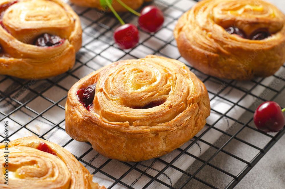 Freshly Baked Puff Pastry with Cherry on Bright Grey Background Freshly Baked Puff Pastry with Cherry on Bright Grey Background