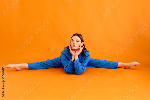 Serious young woman with head on hands sitting on floor