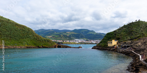 View of the Island Ilheu de Vila Franca do Campo with the town behind in the nature with blue water © Ignacio