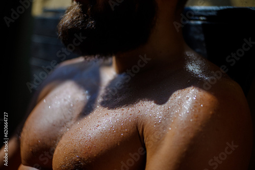 Athletic Wet Man Sunbathing In Summer Sun