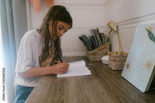 Child writes a thank you note to vacation house host photo