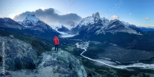 Man on cliff overlooking epic Fitz Roy Patagonia mountain range