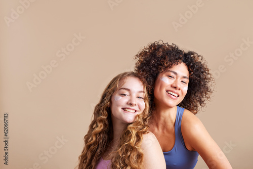 Joyful diverse teen girls smiling at camera in studio photo