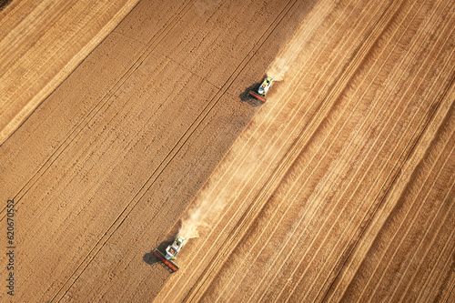 Aerial view combine harvester harvesting on the field.