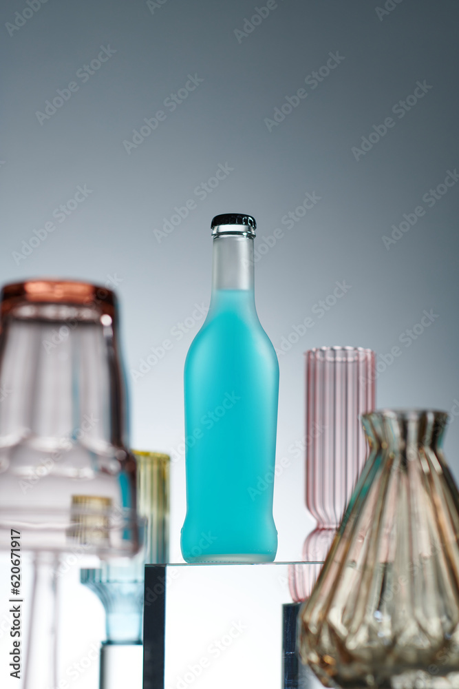 Select a focus soda bottle with colorful glasses goblet around Select a focus soda bottle with colorful glasses goblet around
