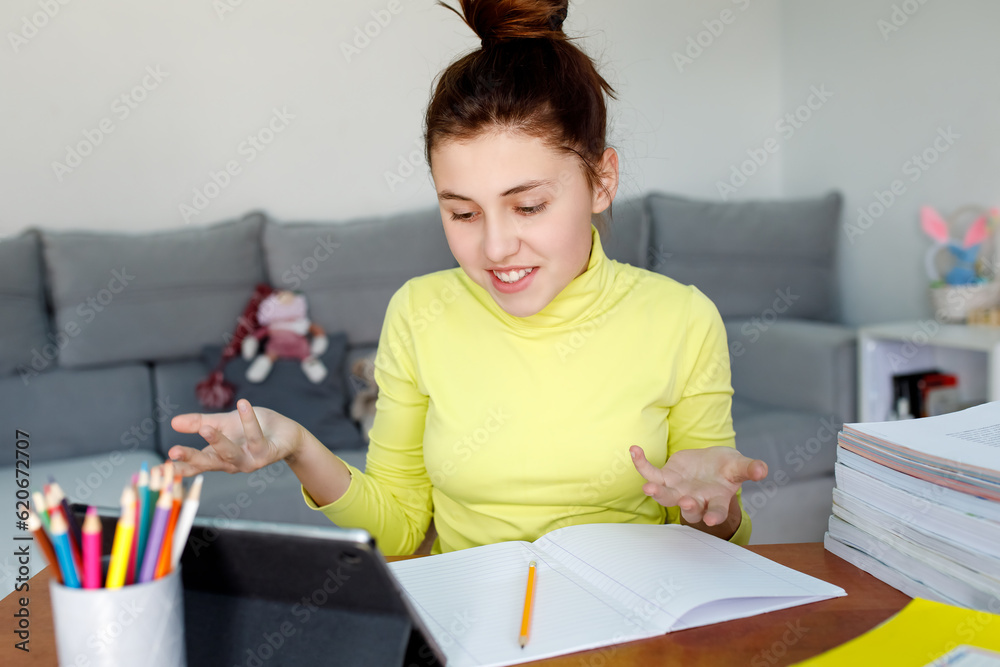 Teenage girl, high school student, communicate remotely via tablet, online learning. Teenage girl, high school student, communicate remotely via tablet, online learning.