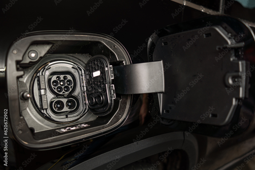 © Alvaro Lavin/Stocksy - electric car charging in home garage