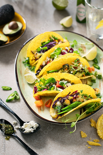 Overhead healthy vegetarian tacos on a plate with ingredients