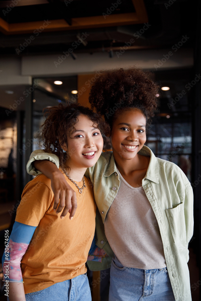 Two smiling female friends spending leisure time together