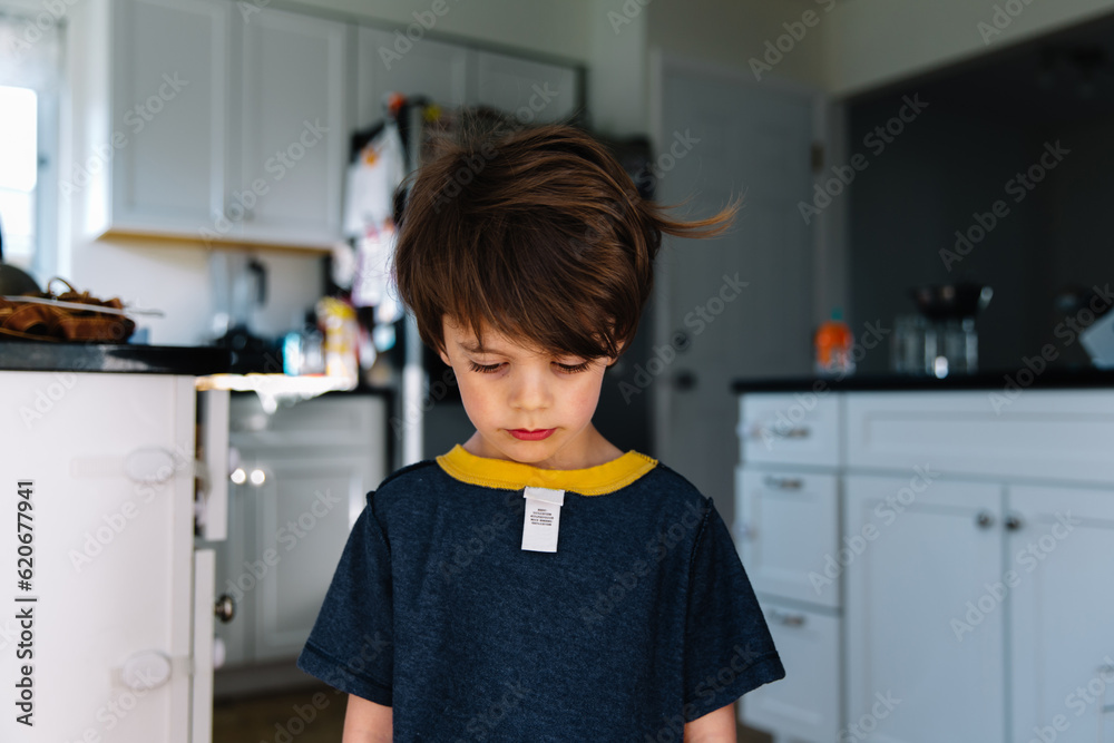 Sad boy with clothes on wrong way Stock Photo | Adobe Stock