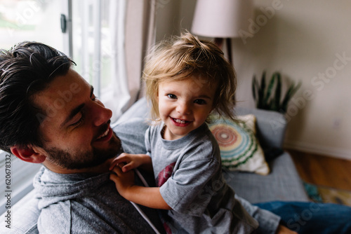 Toddler and Father hug on couch