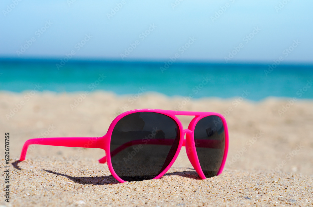  Red sunglasses on a sandy beach