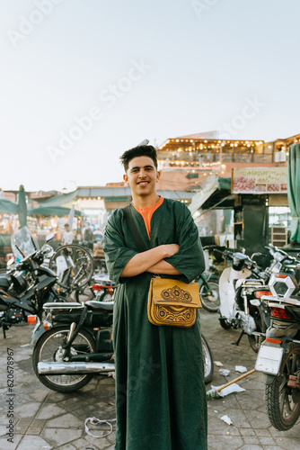 Arab man posing with a bird on his head photo