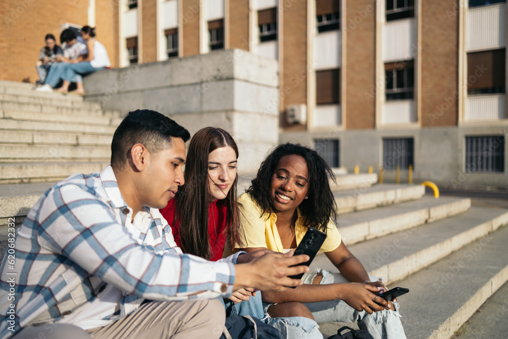 Close up of young people using smartphone outdoors Close up of young people using smartphone outdoors
