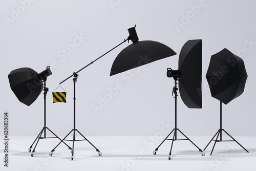 Photography studio flash on a lighting stand on white background