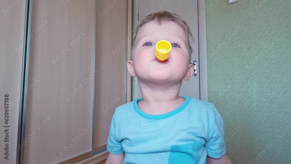 Cheerful little child whistles at home. Copy space concept of